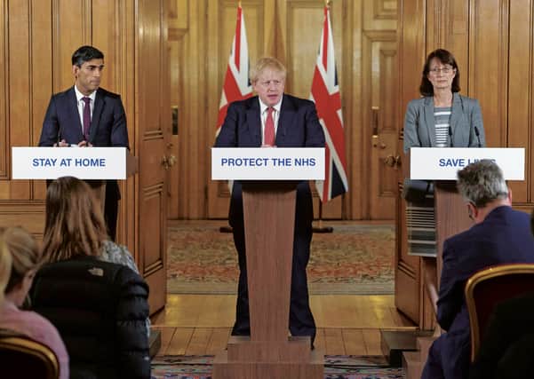 Rishi Sunak, Boris Johnson and Dr Jenny Harries at Friday's press briefing. Picture: Julian Simmonds