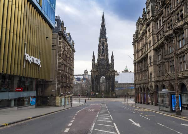 The streets of central Edinburgh may empty during lockdown, but the capital's economy continues to function. Picture: Mark Scates/SNS