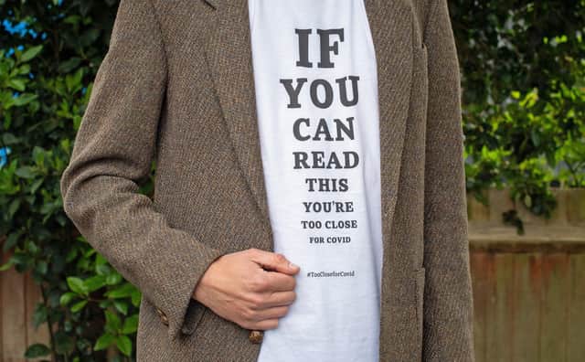A T-shirt which include the slogan: "If you can read this, youâ€TMre too close for COVID" from a range that has been launched by the global brand transformation company FutureBrand as a not-for-profit initiative to help reinforce key social distancing guidelines as the nation emerges from the coronavirus pandemic lockdown. PA Photo. Picture date: Wednesday May 13, 2020. Photo credit should read: Dominic Lipinski/PA Wire