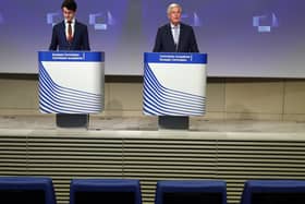 Empty seats are seen in the first two rows as European Union's Brexit negotiator Michel Barnier (R) speaks during a news conference following the third round of Brexit talks. Picture: Getty