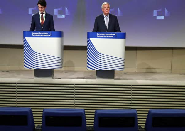 Empty seats are seen in the first two rows as European Union's Brexit negotiator Michel Barnier (R) speaks during a news conference following the third round of Brexit talks. Picture: Getty