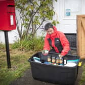 Becs Barker checks the donations left in the "swap shop" box in Minard, Argyll and Bute.