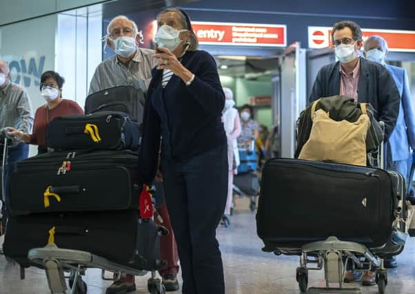 Passengers from the Holland America Line ship Zaandam walk through arrivals in Terminal 2 at Heathrow Airport