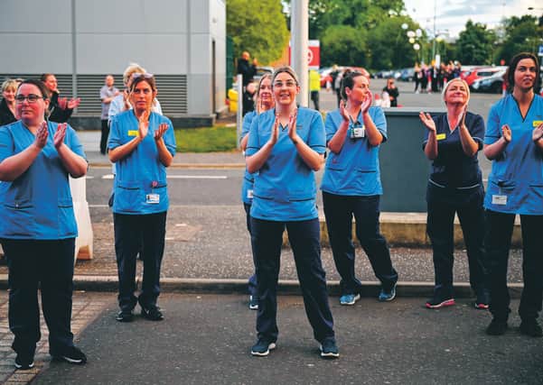 Staff at the Queen Elizabeth Hospital in Glasgow join in the Clap for Carers and key workers last week. Picture: 
Jeff Mitchell/Getty