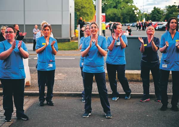 Staff at the Queen Elizabeth Hospital in Glasgow join in the Clap for Carers and key workers last week. Picture:
Jeff Mitchell/Getty
