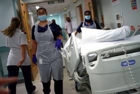 Medical staff transfer a patient along a corridor. Picture: Hannah McKay/AFP via Getty Images