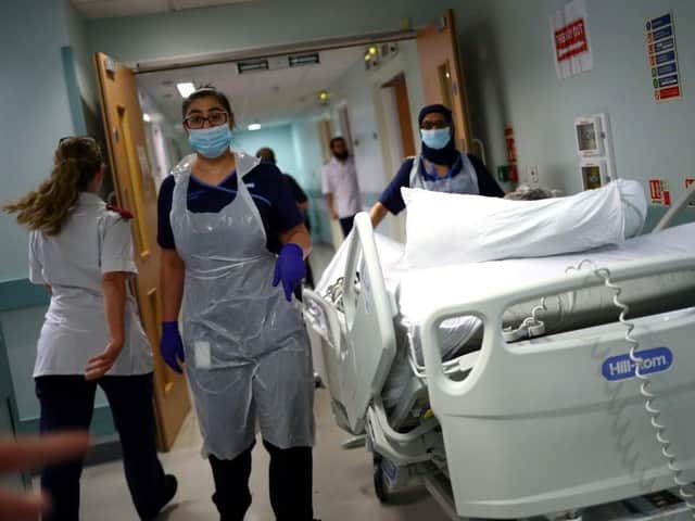 Medical staff transfer a patient along a corridor. Picture: Hannah McKay/AFP via Getty Images