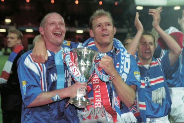 Rangers' Paul Gascoigne (left) and Gordon Durie celebrate the club's ninth successive title, in 1997.