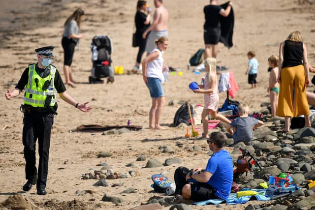 Police speak with members of the public as they enjoy the hottest day of the year in Edinburgh. Picture: Jeff J Mitchell/Getty Images