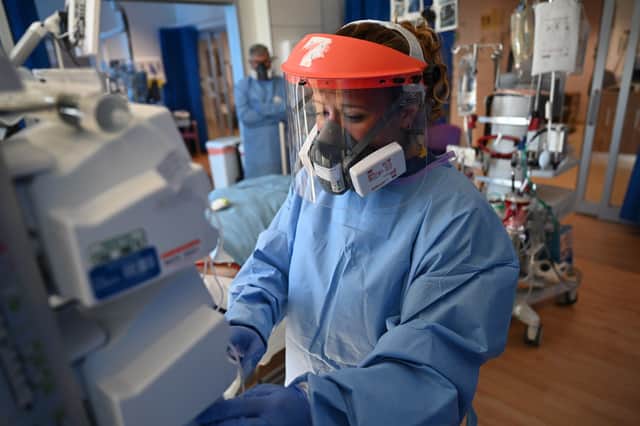 Clinical staff wear Personal Protective Equipment (PPE). Picture: PA
