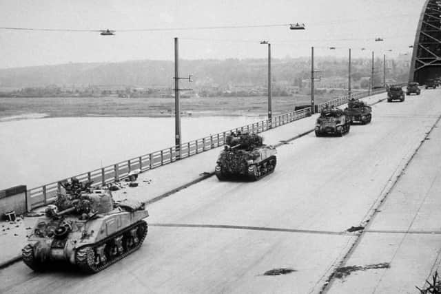 Allied Sherman tanks crossing the newly-captured bridge at Nijmegen in Holland during their advance as part of  'Operation Market Garden'.