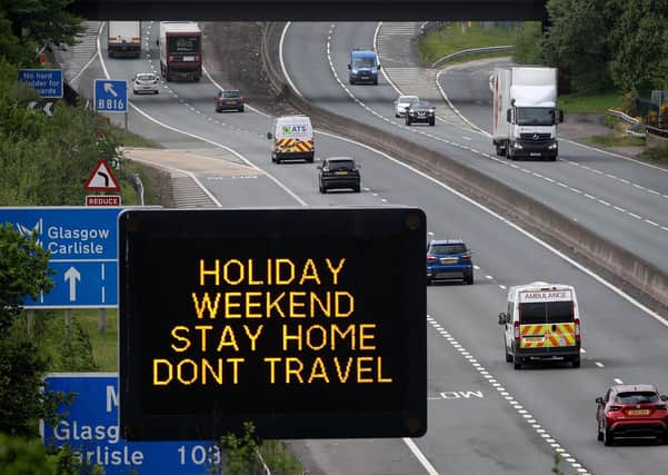 Motorway signage on the M80 at Banknock urging motorists   to stay at home. Picture: PA