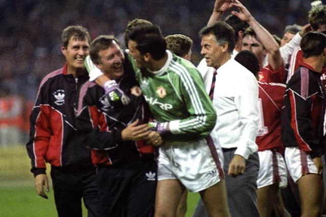 Sir Alex Ferguson celebrates with goalkeeper Les Sealey after winning the FA Cup in 1990. Sealey was brought into the starting line-up for the replay to replace Jim Leighton. Picture: PA/PA Wire