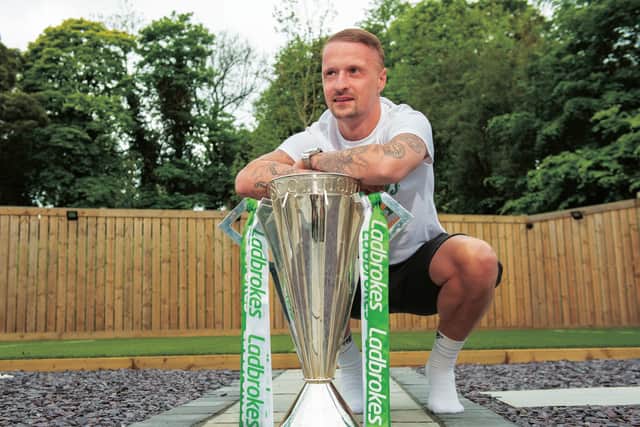 Leigh Griffiths parades the Premiership trophy at his home. Picture: SNS.
