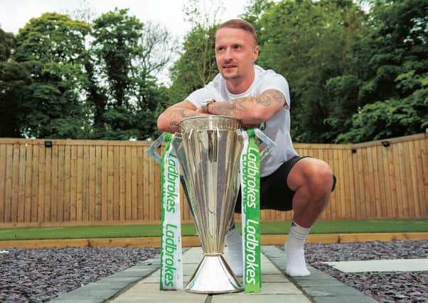 Leigh Griffiths parades the Premiership trophy at his home. Picture: SNS.