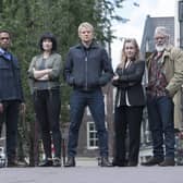 Pictured: (L-R) Luke Allen-Gale as Brad De Vries, Elliot Barnes Worrell as Job Cloovers, Maimie Mccoy as Lucienne Hassell, Marc Warren as Piet Van der Valk, Emma Fielding as Julia Dahlman and Darrell D'silva as Hendrik Davie.