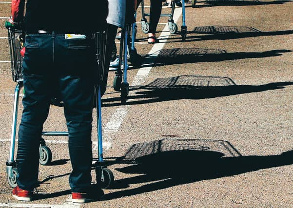 Remember to keep your distance while queueing. Picture: David Rogers/Getty