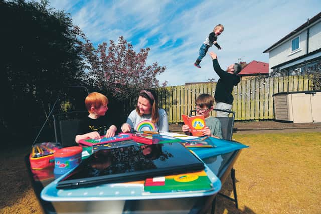 The family of nurse Clare Colligan enjoy a home lesson in their Burnside garden. Picture: John Devlin