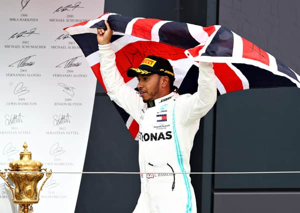 Lewis Hamilton celebrates his British Grand Prix at Silverstone last year. He will defend that title without his fans present. Picture: Getty