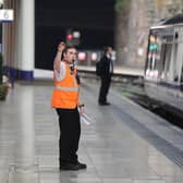 A conductor blows a whistle at Queen Street Station. Picture: John Devlin