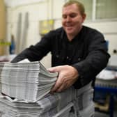 BARNSLEY, ENGLAND - SEPTEMBER 20: A member of the packing team stacks copies of the weekly newspaper as the latest edition is printed at the Barnsley Chronicle press during a nightshift on September 20, 2018 in Barnsley, England. The latest newspaper circulation figures, covering 2017, listed a readership of 19,855 copies per week. Launched in 1858, the Barnsley Chronicle is one of the last privately-owned weekly newspapers in the country, producing each copy in house with their own journalists, design team and full printing press. Owned and operated by the Hewitt family since 1923, it is the largest circulating weekly newspaper in Yorkshire, with profits boosted by off-shoot companies such as military history publishers Pen and Sword and go-kart company Tyke Racing, operating under the Acredula Group. (Photo by Leon Neal/Getty Images)