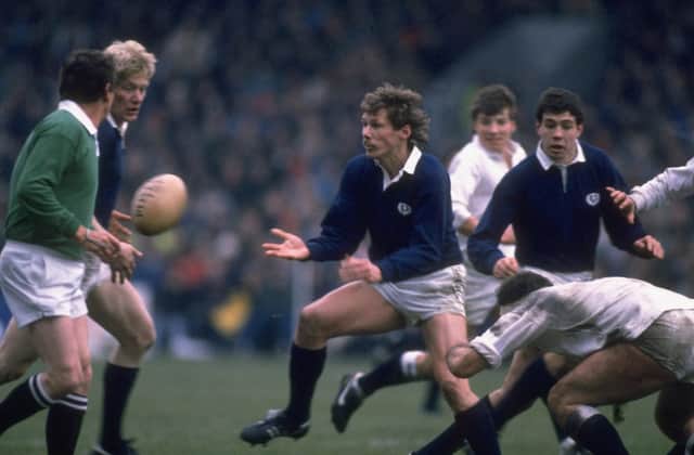 John Rutherford passes the ball to John Jeffrey during Scotland's 33-6 demolition of England in the 1986 Calcutta Cup match at Murrayfield. Picture: Getty Images