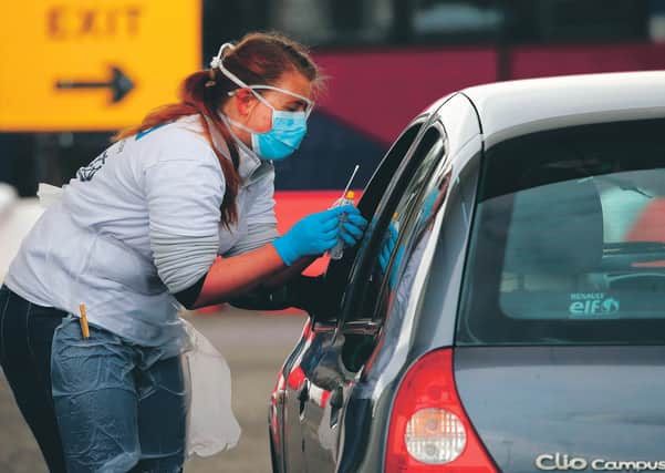 A medical worker tests a key worker for the novel coronavirus Covid-19 at a drive-in testing centre at Glasgow Airport. Picture: PA