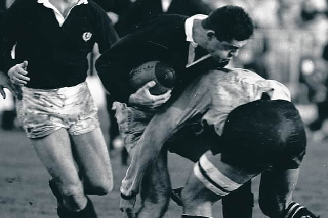 Gavin Hastings is tackled by All Blacks skipper Buck Shelford