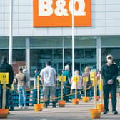 Members of the public follow social distancing guidelines and queue in the car park of B&Q. Picture PA
