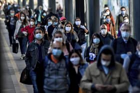 Commuters return to work in Milan, Italy. Britain is facing a similar challenge to get employees back into work and to restart the UK economy. Picture: Claudio Furlan/LaPresse via AP