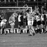 Dejected Celtic players look on as Feyenoord celebrate the winning goal in extra time