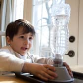 You can recreate a tornado at home, using everyday items from your kitchen, like this little boy