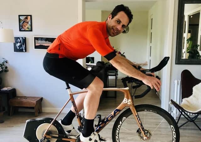 Cyclist Mark Beaumont on the turbo trainer in his living room.
