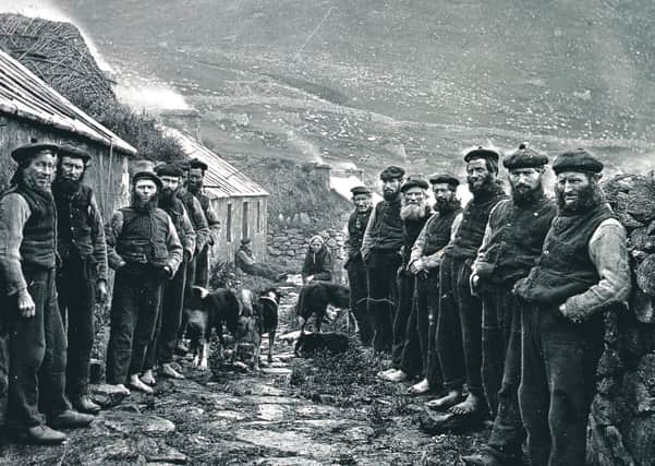 Men on either side of the street forming the St Kilda Parliament in the Village on the island of Hirta, St Kilda.