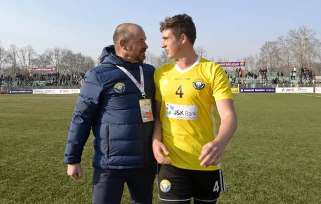 Real Kashmir manager David Robertson and his son Mason, who plays for the club, leave the pitch after winning their I-League match against Chennai City in Srinagar in January 2019. Picture: Tauseef Mustafa/AFP via Getty Images
