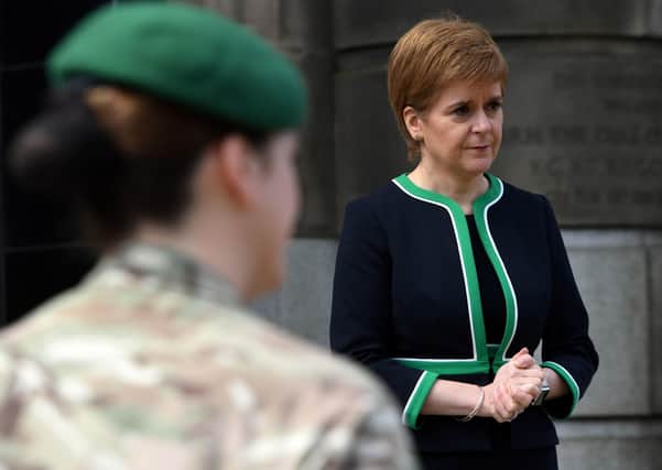 Scotland's First Minister Nicola Sturgeon speaks to members of the armed forces after observing a two-minute silence outside St Andrew's House in Edinburgh to mark the 75th anniversary of VE Day. (Picture: Andy Buchanan/PA Wire)