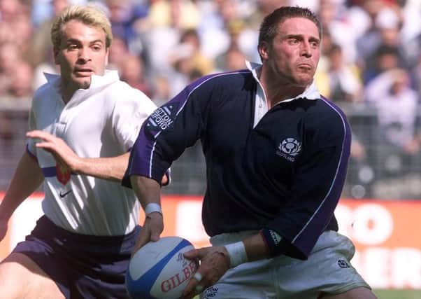 Alan Tait, playing brilliant rugby late in his career, leaves French opponent Christophe Dominici in his wake. He scored two tries in this 1999 victory. Picture: AFP/Getty.