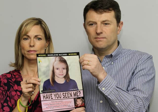 Kate and Gerry McCann hold a missing poster depicting a computer-generated image of their daughter Madeleine as she might look at the age of nine in 2021 (Picture: Sang Tan/AP)