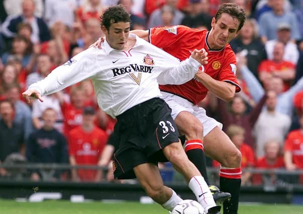 Manchester United’s Gary Neville tackles Sunderland’s Julio Arca during a match at Old Trafford in 2000. Picture: PA