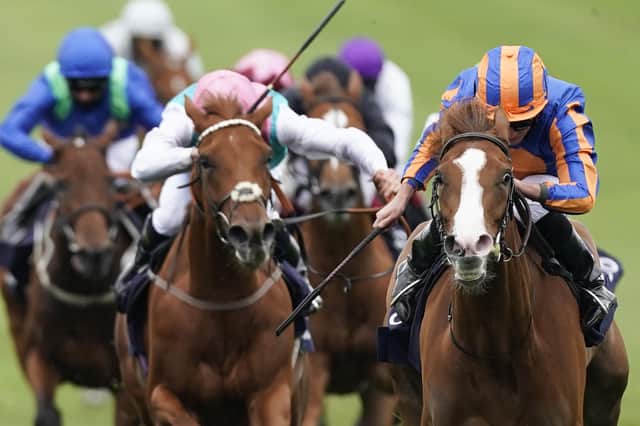 Jockey Ryan Moore and Love, right, surge clear to win the Qipco 1,000 Guineas at Newmarket. Picture: Alan Crowhurst/PA Wire
