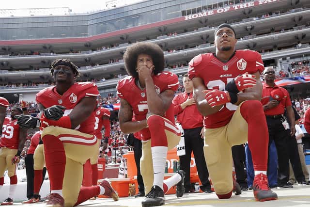 San Francisco 49ers trio Eli Harold, Colin Kaepernick and Eric Reid kneel during the national anthem. Picture: Marcio Jose Sanche/AP