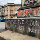 The words 'son of slaver Dundas' and 'colonialist profiteer'  on the base of the Robert Dundas statue in Melville Street