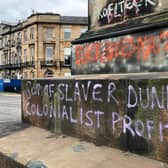 The words 'son of slaver Dundas' and 'colonialist profiteer'  on the base of the Robert Dundas statue in Melville Street