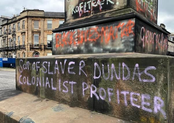 The words 'son of slaver Dundas' and 'colonialist profiteer' on the base of the Robert Dundas statue in Melville Street