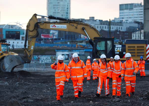 Prime Minister Boris Johnson talks with apprentices during a visit to Curzon Street railway station in Birmingham where the HS2 rail project is under construction.