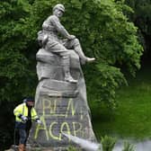 Council workers clean a war memorial commemorating the Second Boer War. Picture: John Devlin