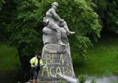 Council workers clean a war memorial commemorating the Second Boer War. Picture: John Devlin