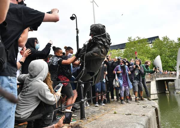 The statue of slave trader Edward Colston is thrown in Bristol harbour (Picture: Ben Birchall/PA Wire)