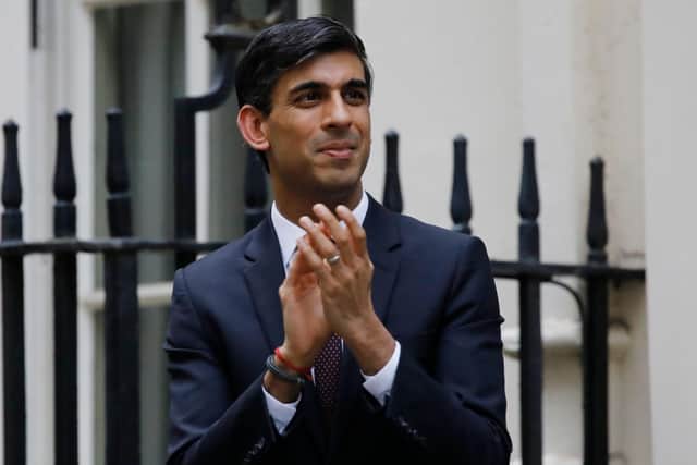 Chancellor Rishi Sunak, taking part in a nationwide clap for carers, announced the furlough scheme at the start of the lockdown. (Photo by Tolga Akmen/AFP via Getty Images)