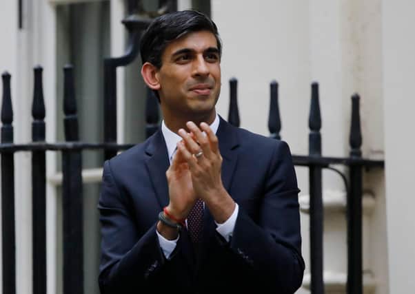 Chancellor Rishi Sunak, taking part in a nationwide clap for carers, announced the furlough scheme at the start of the lockdown. (Photo by Tolga Akmen/AFP via Getty Images)